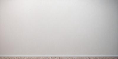 The primary subject of the image is a white wall. The setting is a room with a wooden floor. The visual style is a photo of a plain white wall. The colors and mood are predominantly white, giving the image a clean and minimalistic appearance.