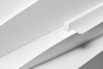 The primary subject of the image is a white piece of paper. The setting is a white background, which creates a clean and minimalist appearance. The visual style is a close-up of the paper, emphasizing its texture and details. The colors and mood are predominantly white, giving the image a calm and serene atmosphere.
