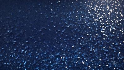 The primary subject of the image is a blue background with a pattern of glittering stars. The setting appears to be a night sky, and the visual style is a combination of a photo and digital art. The colors are predominantly blue, with the stars adding a touch of white. The overall atmosphere is one of beauty and tranquility.