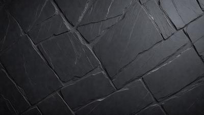 The primary subject of the image is a close-up of a black stone wall. The setting is a dark room, and the visual style is a photo. The dominant colors are black and grey, creating a moody atmosphere.