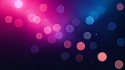 The primary subject of the image is a colorful, pink and blue background with a pattern of circles. The setting is a dark background, which contrasts with the bright colors of the circles. The visual style appears to be a digital art or illustration, as the circles are arranged in a visually appealing manner. The dominant colors of the image are pink and blue, creating a vibrant and lively atmosphere.