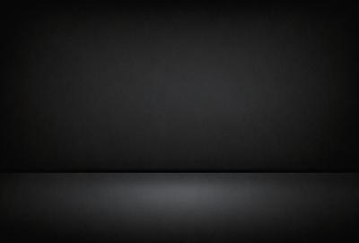 The primary subject of the image is a black background. The setting is a dark room, and the visual style is a black and white photo. The colors and mood of the image are predominantly dark and moody.
