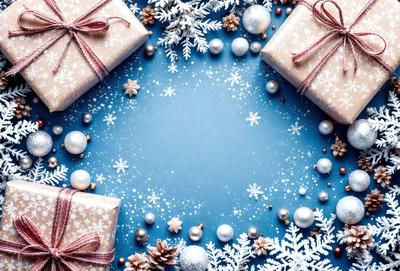 The primary subject of the image is a blue background with snowflakes and pinecones scattered across it. The setting is a winter scene, and the visual style is a combination of photo and digital art. The dominant colors are blue and white, creating a calm and serene atmosphere.
