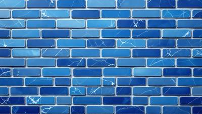 The primary subject of the image is a blue brick wall with a pattern of white and blue tiles. The setting is a room with a blue brick wall as the main focus. The visual style is a close-up of the blue brick wall, showcasing its unique pattern. The colors and mood of the image are predominantly blue, creating a calm and serene atmosphere.