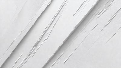 The primary subject of the image is a white wall with a pattern of dripping paint. The setting is a room with a white background, and the visual style appears to be a photo of the wall. The colors and mood of the image are predominantly white, giving it a clean and minimalist appearance.