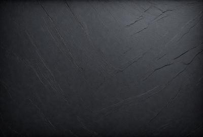 The primary subject of the image is a black leather surface, which appears to be a leather-like material or a leather-textured wallpaper. The setting is a dark room, and the visual style is a close-up of the leather surface. The colors and mood of the image are predominantly dark and moody, with the black leather surface being the main focus.