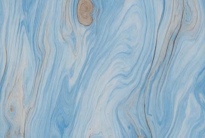 The primary subject of the image is a close-up of a blue and white marbled wood grain. The setting is a blue and white marbled wood grain surface, which serves as the background. The visual style is a close-up of the marbled wood grain, showcasing its unique texture and pattern. The colors and mood of the image are predominantly blue and white, creating a calm and serene atmosphere.