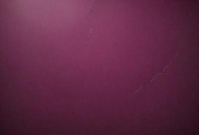 The primary subject of the image is a purple wall with a few white lines on it. The setting is a room with a purple wall, and the visual style appears to be a photo. The dominant colors are purple and white, creating a calm and soothing atmosphere.