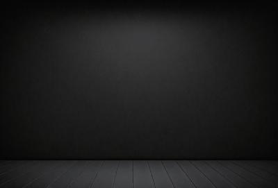 The primary subject of the image is a black wall with a black background. The setting is a room with a wooden floor. The visual style is a black and white photo. The dominant colors and overall atmosphere are dark and moody.