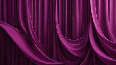 The primary subject of the image is a purple curtain, which is the main object, scene, or focus of the image. The setting is a stage or theater, with the curtains hanging in the background. The visual style is a photo, and the dominant colors are purple and pink, creating a warm and inviting atmosphere.
