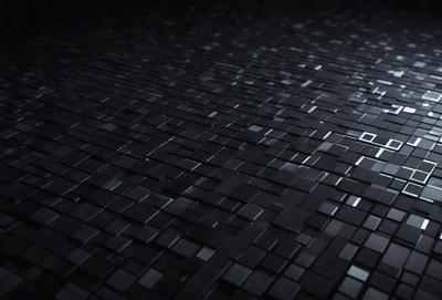 The primary subject of the image is a black and white patterned tile. The setting is a dark room, and the visual style is a close-up of the tile. The colors and mood of the image are predominantly black and white, creating a stark and minimalist atmosphere.