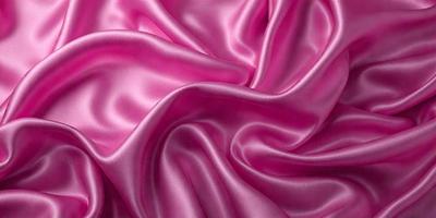 The primary subject of the image is a close-up of a pink fabric, possibly a silk material. The setting is a pink background, which complements the color of the fabric. The visual style appears to be a photo, showcasing the intricate details of the fabric. The colors and mood of the image are predominantly pink, creating a warm and inviting atmosphere.