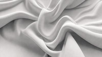 The primary subject of the image is a white sheet of fabric, which is the main object, scene, or focus of the image. The setting or background is a white sheet of fabric, and the visual style is a photo. The colors and mood of the image are predominantly white, giving it a clean and minimalist appearance.