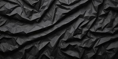 The primary subject of the image is a black and white photograph of a wall with a pattern of wrinkled paper. The setting is a black background, and the visual style is a close-up of the paper pattern. The colors and mood of the image are predominantly black and white, giving it a classic and timeless appearance.