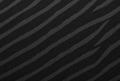 The primary subject of the image is a black and white zebra pattern. The setting is a black background, and the visual style is a photo. The dominant colors are black and white, and the overall atmosphere is bold and striking.