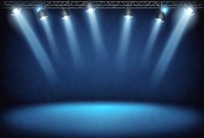 The primary subject of the image is a stage with a blue background. The stage is illuminated by a series of bright lights, creating a dramatic and captivating atmosphere. The setting is a theater or a performance venue, and the visual style is a combination of photo and digital art. The colors and mood of the image are predominantly blue, creating a sense of calmness and sophistication.