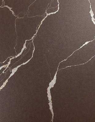 The primary subject of the image is a close-up of a marble surface with a brown background. The setting appears to be a room with a brown wall. The visual style is a photo, and the colors and mood are warm and earthy.