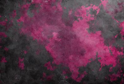 The primary subject of the image is a close-up of a purple and pink patterned surface. The setting is a dark background, which contrasts with the vibrant colors of the pattern. The visual style appears to be a combination of digital art and illustration, creating a unique and eye-catching design. The dominant colors in the image are purple and pink, which evoke a sense of warmth and creativity.