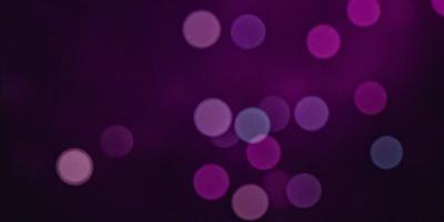 The primary subject of the image is a purple background with a pattern of bright, round, pink lights. The setting appears to be a dark room, and the visual style is a combination of a photo and digital art. The colors and mood of the image are predominantly purple and pink, creating a warm and inviting atmosphere.