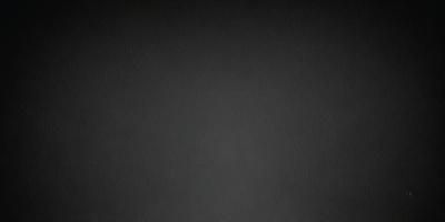 The primary subject of the image is a black background. The setting is a dark, empty space. The visual style is a black and white photo. The colors and mood are dark and moody.