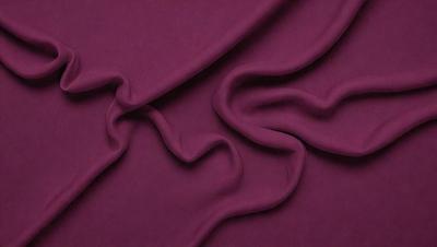 The primary subject of the image is a purple fabric, which is the main object, scene, or focus of the image. The setting or background is a purple sheet, and the visual style is a close-up of the fabric. The colors and mood of the image are predominantly purple, creating a calm and soothing atmosphere.