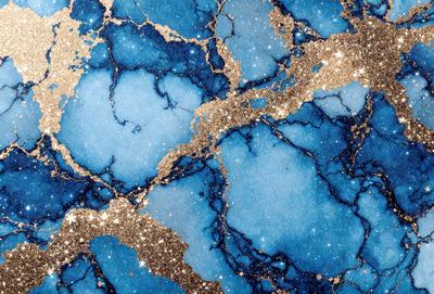 The primary subject of the image is a blue and gold patterned wallpaper. The setting is a blue and gold wallpapered room. The visual style is a close-up of the wallpaper, showcasing the intricate design. The dominant colors are blue and gold, creating a warm and inviting atmosphere.
