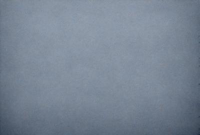 The primary subject of the image is a large, empty, and dark blue sky. The setting is a vast, open space with no visible landmarks or objects. The visual style is a natural, untouched, and unaltered representation of the sky. The colors and mood convey a sense of calmness and tranquility, as the sky appears to be void of any disturbances or activity.