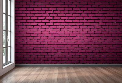 The primary subject of the image is a brick wall with a purple hue. The setting is a room with a wooden floor. The visual style is a photo, and the dominant colors are purple and brown. The overall atmosphere is a mix of modern and rustic, with the purple brick wall adding a touch of color and uniqueness to the space.