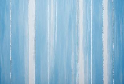 The primary subject of the image is a blue and white striped wallpaper. The setting is a room with a blue and white striped wallpaper. The visual style is a patterned wallpaper. The dominant colors are blue and white, creating a calm and soothing atmosphere.