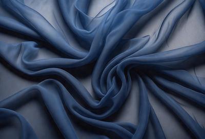 The primary subject of the image is a blue fabric, which appears to be a piece of cloth or a curtain. The setting is a white surface, which provides a clean and uncluttered backdrop for the blue fabric. The visual style of the image is a close-up, focusing on the details of the blue fabric. The colors and mood of the image are predominantly blue, creating a calm and serene atmosphere.