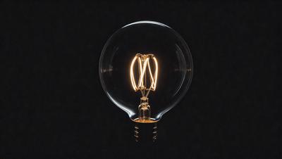 The primary subject of the image is a light bulb, which is the main object in the scene. The light bulb is illuminated, creating a warm and inviting atmosphere. The setting is a dark background, which contrasts with the light bulb, emphasizing its brightness. The visual style of the image is a close-up of the light bulb, showcasing its intricate details. The colors and mood of the image are predominantly warm and cozy, with the light bulb being the foc