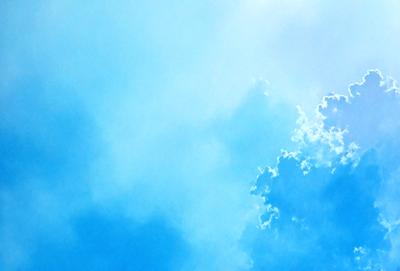 The primary subject of the image is a cloudy blue sky. The setting is a vast expanse of the sky, with no visible land or other objects. The visual style is a natural, outdoor scene. The colors and mood are predominantly blue, with some white clouds, creating a serene and peaceful atmosphere.