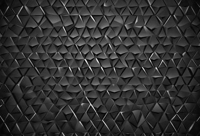 The primary subject of the image is a black and white patterned wall. The setting is a dark room with a black background. The visual style is a close-up of the patterned wall, which gives a sense of depth and texture. The dominant colors are black and white, creating a moody and dramatic atmosphere.