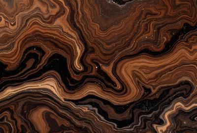 The primary subject of the image is a close-up of a marbled stone surface. The setting is a dark room, and the visual style appears to be a photo of the stone. The colors and mood of the image are dark and moody, with the marbled stone surface being the main focus.