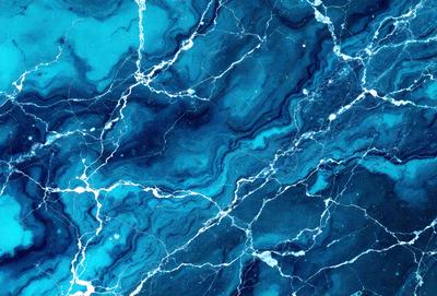 The primary subject of the image is a blue and white marbled surface, which appears to be a piece of art or a decorative item. The setting is a room with a blue and white marbled wall, which adds a unique and visually appealing touch to the space. The visual style of the image is a close-up of the marbled surface, showcasing its intricate patterns and textures. The colors and mood of the image are predominantly blue and white, creating a sense of calmness and soph