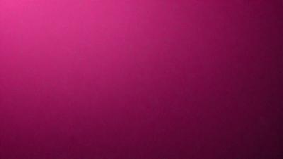 The primary subject of the image is a large, pink wall. The setting is a room with a pink background, and the visual style is a close-up of the wall. The dominant colors in the image are pink, and the overall atmosphere is warm and inviting.
