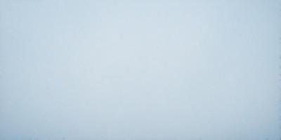 The primary subject of the image is a large, empty, and white canvas. The setting is a blank, white background, which creates a sense of emptiness and simplicity. The visual style is a simple, clean, and minimalist representation of the canvas. The colors and mood are predominantly white, which gives the image a calm and serene atmosphere.