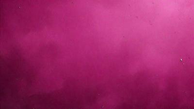 The primary subject of the image is a large, pink surface. The setting appears to be a room with a pink wall, and the visual style is a close-up of the pink wall. The dominant colors in the image are pink, and the overall atmosphere is warm and inviting.