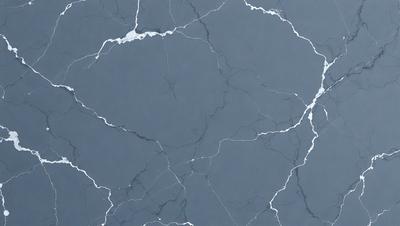 The primary subject of the image is a close-up of a gray marble wall with a rough texture. The setting is a room with a blue-gray color scheme. The visual style is a realistic representation of the marble wall. The colors and mood of the image are dark and moody, with the gray marble and blue-gray walls creating a sense of depth and sophistication.