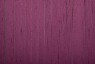 The primary subject of the image is a purple wall with a wooden texture. The setting is a room with a wooden wall, and the visual style is a close-up of the wall. The dominant colors are purple and brown, creating a warm and inviting atmosphere.