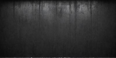 The primary subject of the image is a black wall with a textured surface. The setting is a dark room, and the visual style appears to be a photo. The dominant colors are black and grey, creating a moody atmosphere.