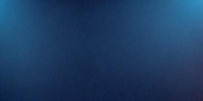 The primary subject of the image is a large body of water, which appears to be a deep blue ocean. The setting is a vast expanse of water, with no visible land or other objects. The visual style of the image is a realistic representation of the ocean, with no indication of digital art or illustration. The colors and mood of the image are predominantly blue, creating a serene and tranquil atmosphere.