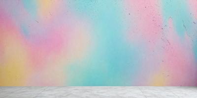 The primary subject of the image is a colorful wall with a variety of colors, including pink, blue, green, and yellow. The setting is a room with a white table in front of the wall. The visual style of the image is a combination of photo and digital art, creating a vibrant and lively atmosphere. The dominant colors and overall mood of the image are energetic and cheerful, with the colorful wall serving as a striking backdrop.