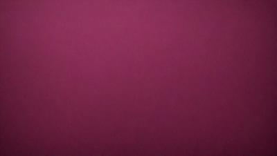 The primary subject of the image is a large, pink wall. The setting is a room with a pink background, and the visual style is a close-up of the wall. The dominant colors are pink, and the overall atmosphere is warm and inviting.