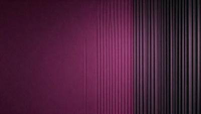 The primary subject of the image is a purple wall with a striped pattern. The setting is a room with a purple wall, and the visual style is a close-up of the wall. The dominant colors are purple and white, creating a calm and soothing atmosphere.