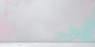 The primary subject of the image is a white wall with a blue stain on it. The setting is a room with a white table. The visual style is a photo, and the colors and mood are predominantly white and blue, with a hint of green.