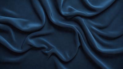 The primary subject of the image is a blue fabric, which appears to be a piece of cloth or a curtain. The setting is a dark room, and the visual style is a close-up of the fabric. The colors and mood of the image are predominantly dark and moody, with the blue fabric being the main focus.