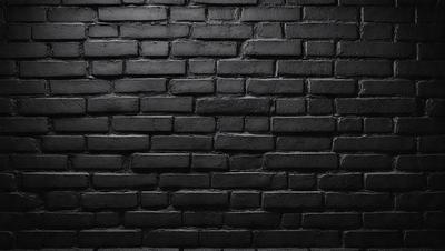 The primary subject of the image is a brick wall. The setting is a dark room, and the visual style is a black and white photo. The dominant colors are black and white, creating a moody atmosphere.