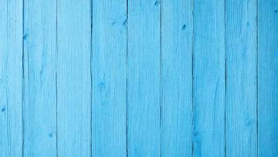 The primary subject of the image is a blue wooden wall. The setting is a room with a blue wooden wall, and the visual style is a photo. The dominant colors are blue and white, creating a calm and serene atmosphere.