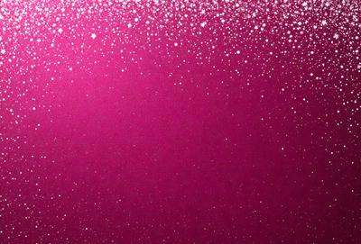 The primary subject of the image is a pink background with a pattern of white stars. The setting is a dark background, which contrasts with the pink and white stars. The visual style is a combination of a photo and digital art, creating a unique and eye-catching design. The colors and mood of the image are predominantly pink and white, giving it a warm and inviting atmosphere.